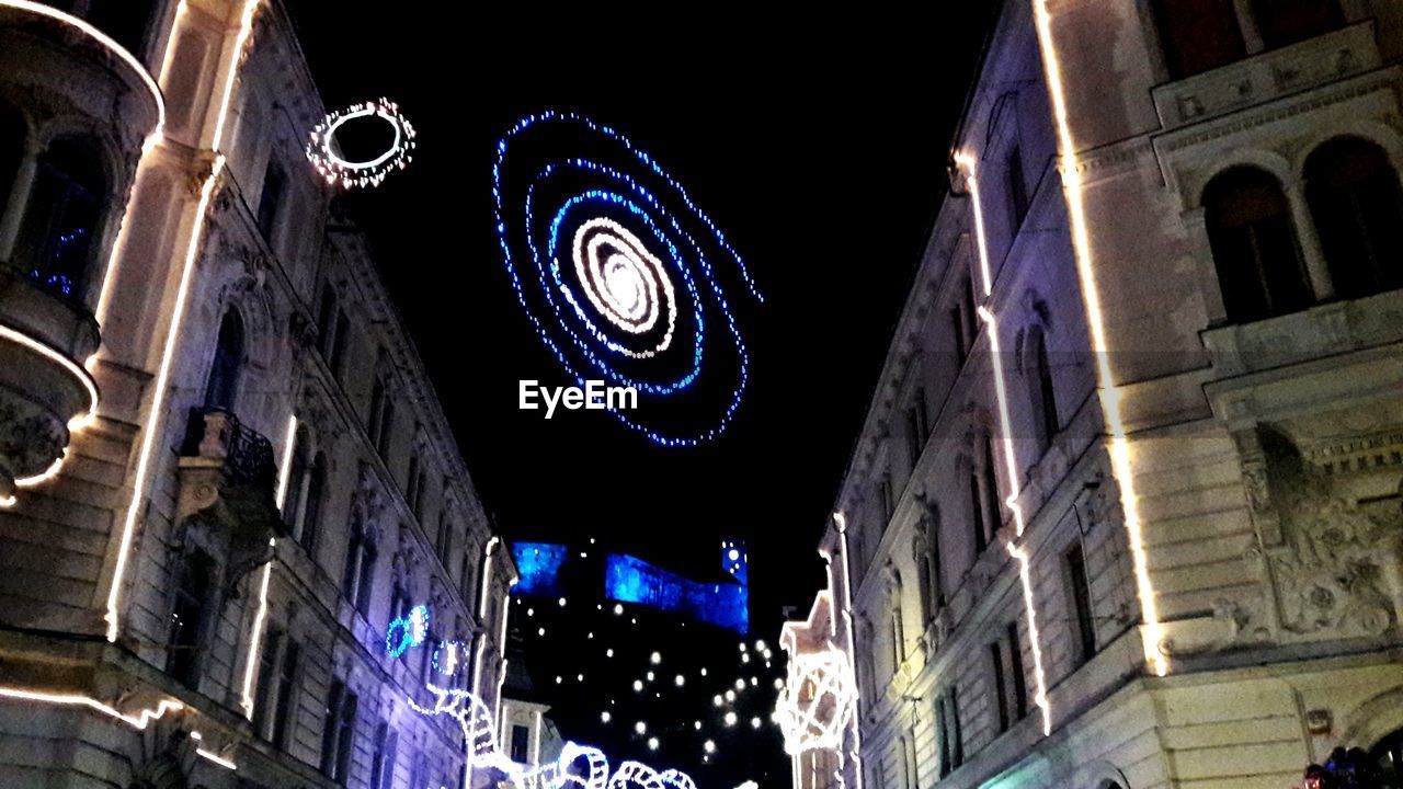 LOW ANGLE VIEW OF ILLUMINATED BUILDING