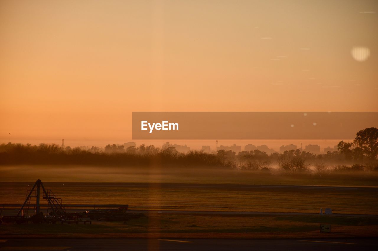 Scenic view of field against sky during sunset