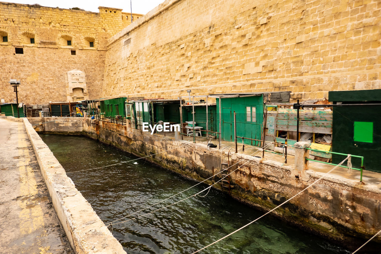 Valletta, malta. ancient fishermen's houses and warehouses at the canal