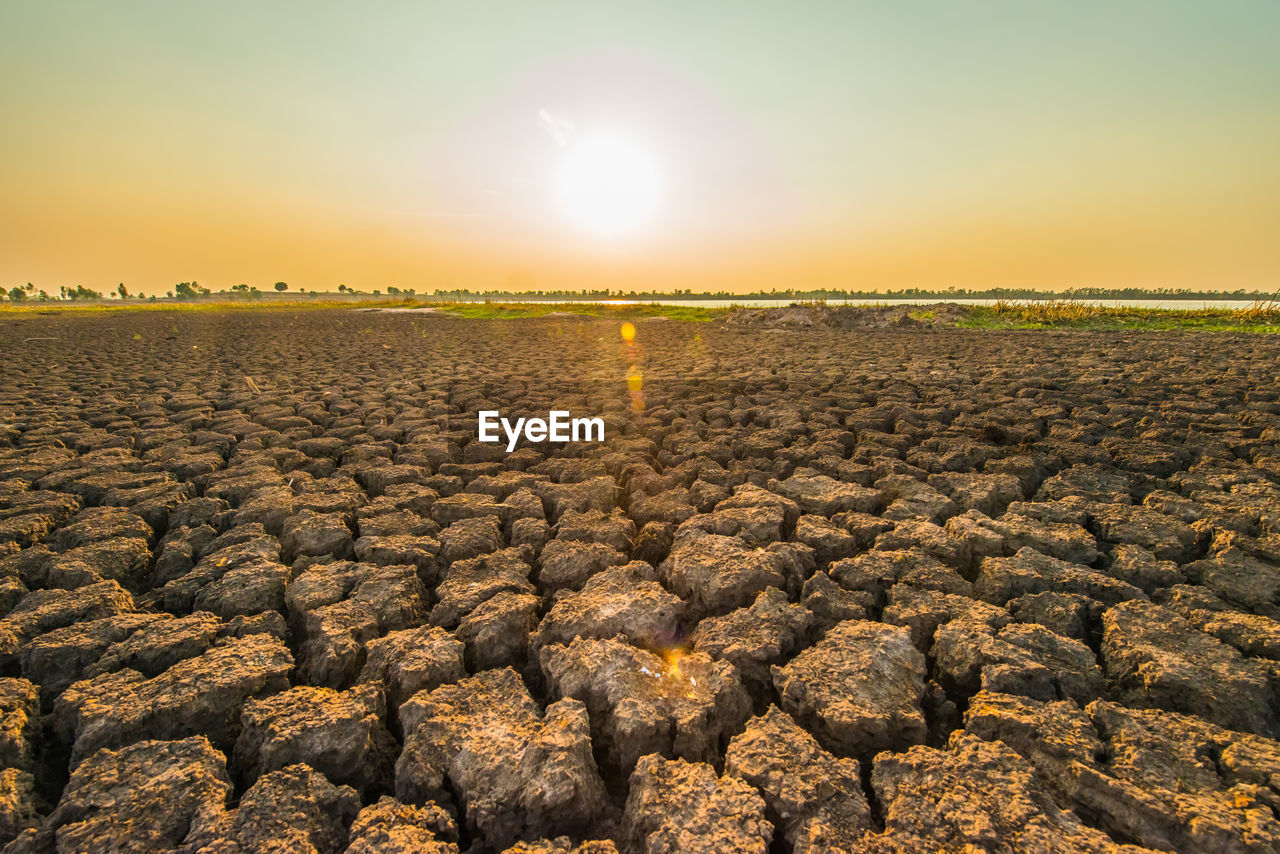 Scenic view of field against sky during sunset