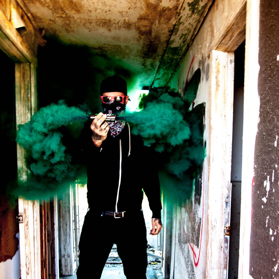 Man holding distress flare in abandoned building