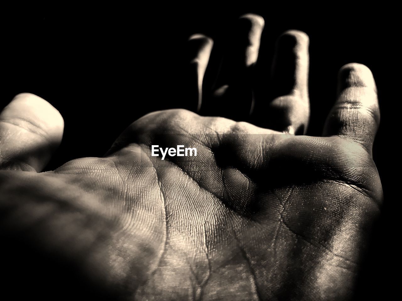 Close-up of man hand against black background