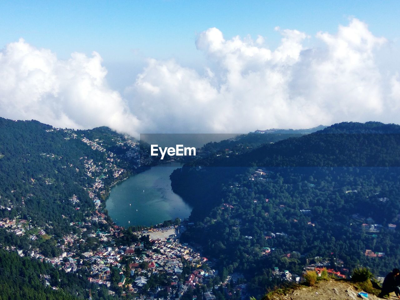 High angle view of town by sea against sky