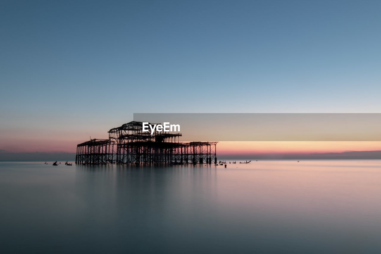 Scenic view of sea against clear sky during sunset