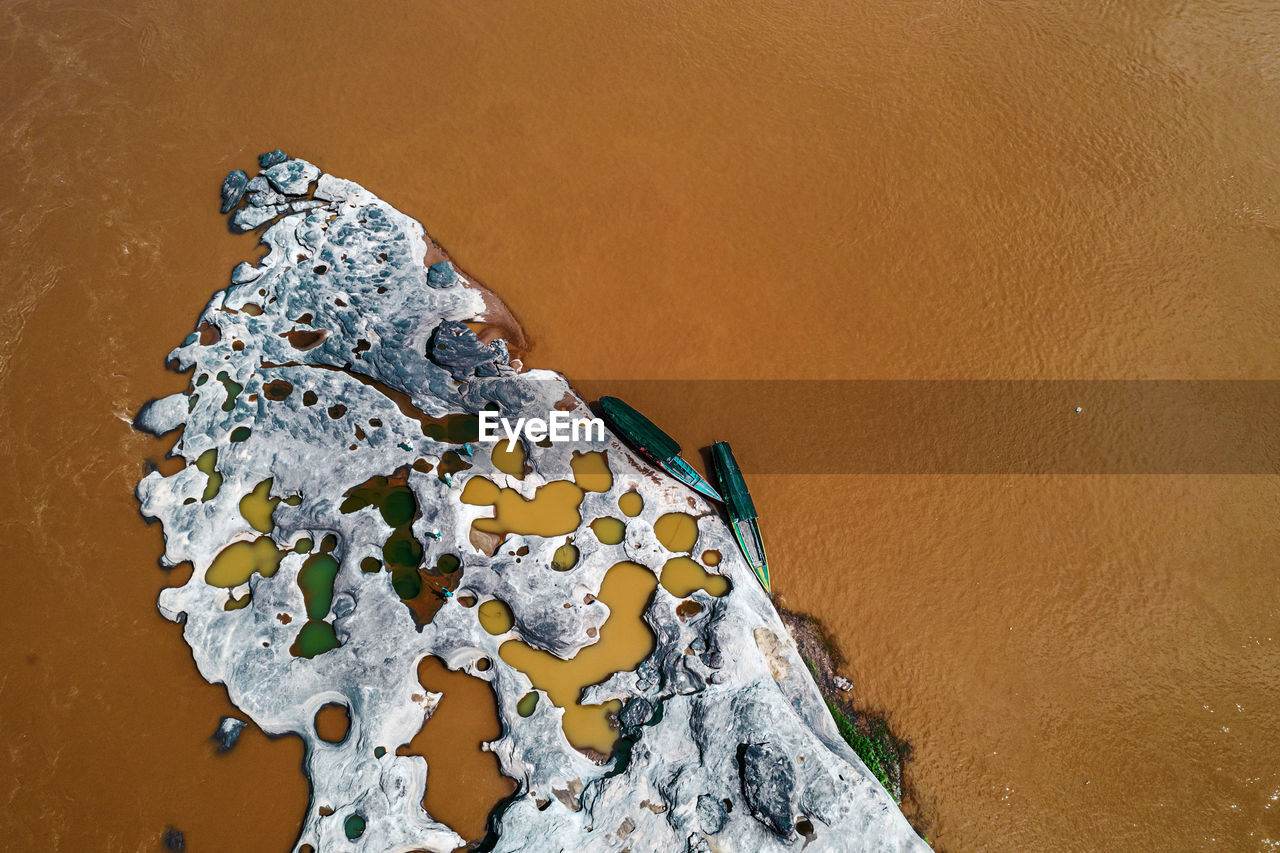 High angle view of rock on sand