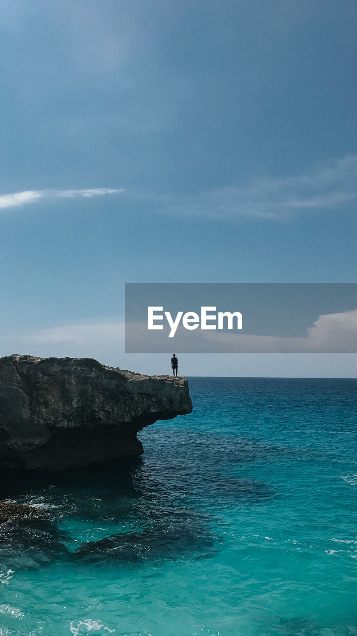 SCENIC VIEW OF ROCKS IN SEA AGAINST SKY