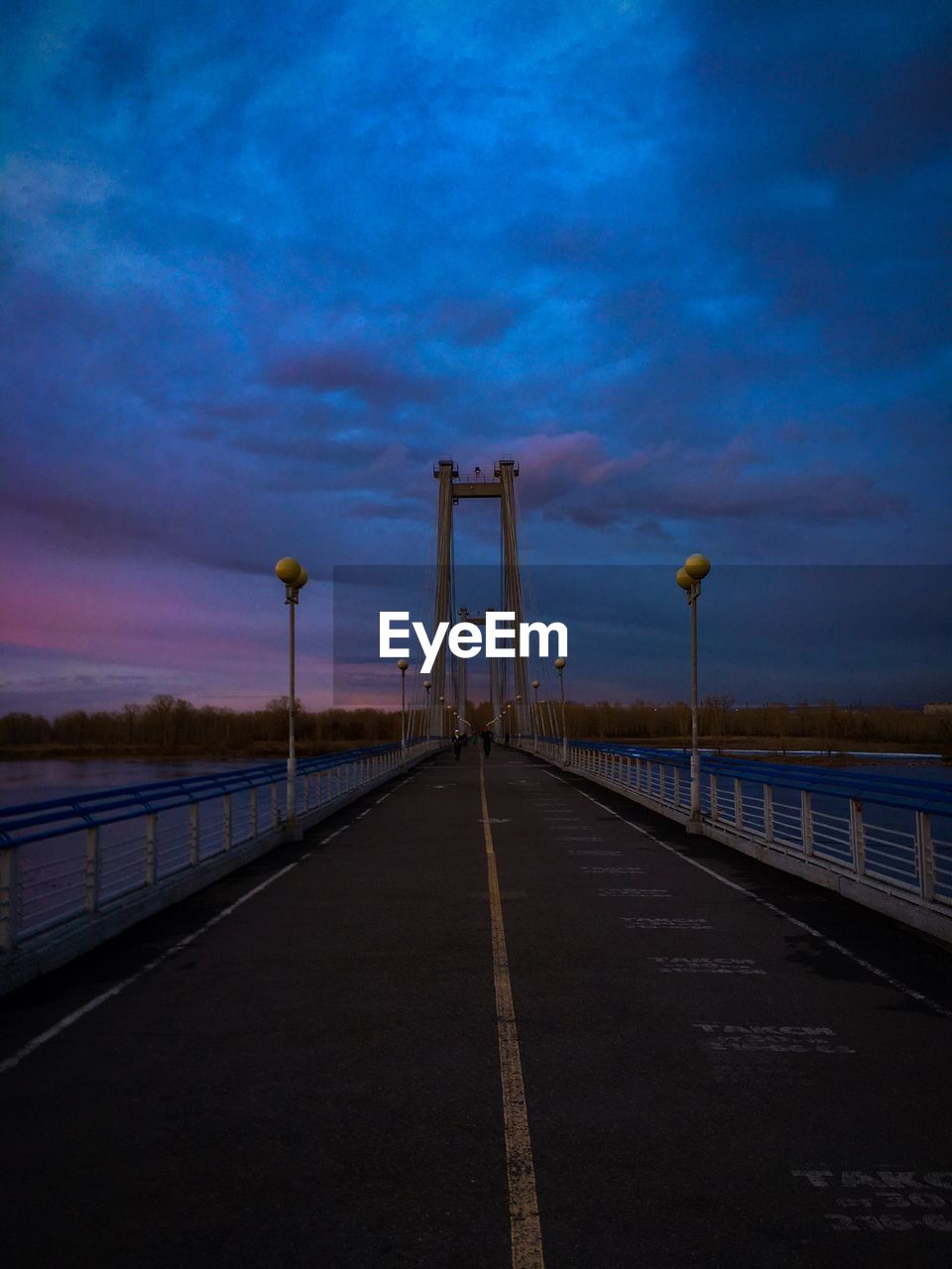 VIEW OF BRIDGE OVER ROAD AGAINST SKY