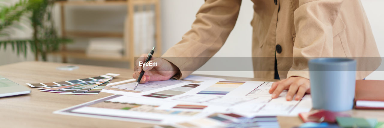 midsection of businessman working at desk in office