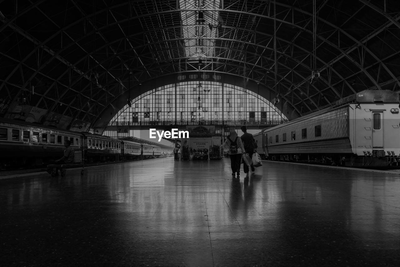 Long exposure of people walking on railroad station platform in bangkok thailand