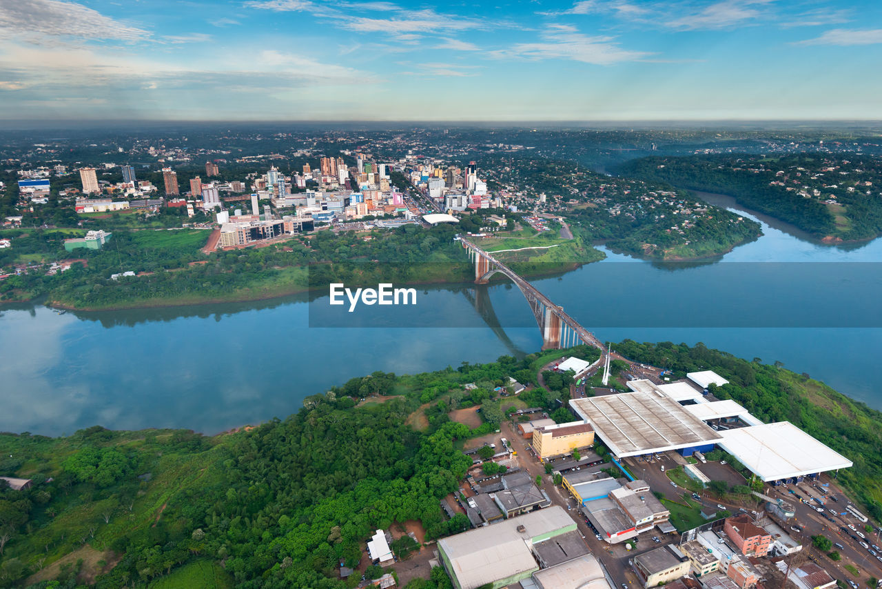 High angle view of river and cityscape against sky