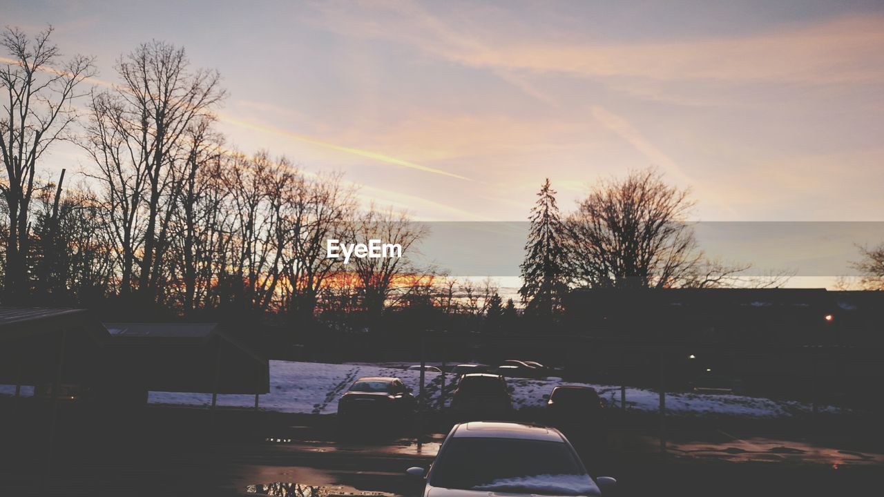 Cars in parking lot at sunset during winter