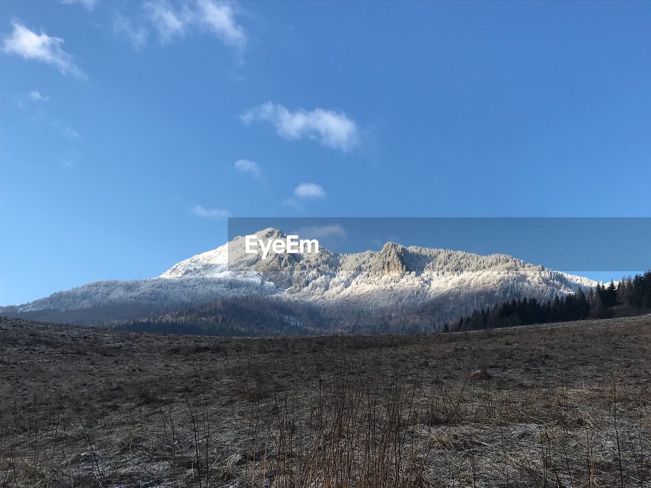 Scenic view of mountains against blue sky