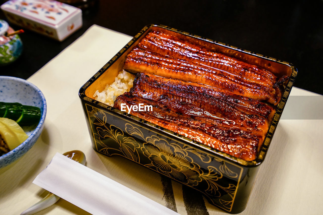 Broiled eel served over rice in a lacquered box