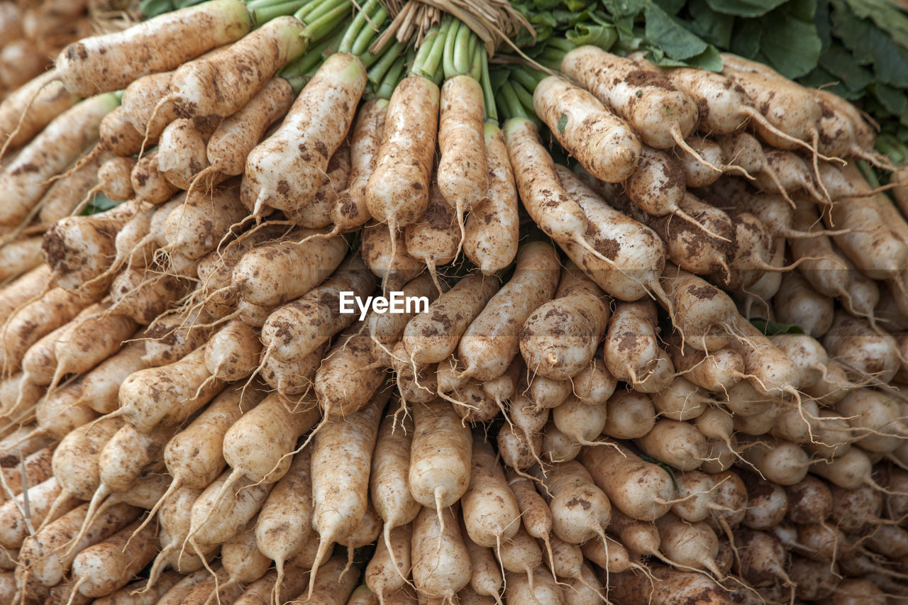 Full frame shot of daikon radish for sale at market stall