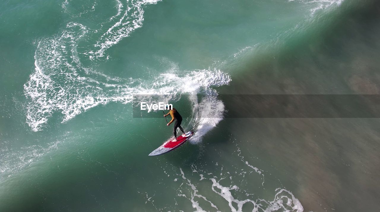 High angle view of man surfing in sea/colours on the wave