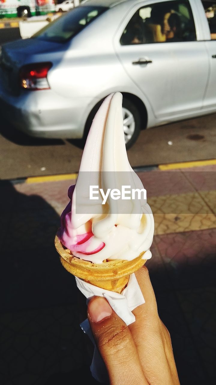 MIDSECTION OF PERSON HOLDING ICE CREAM CONE