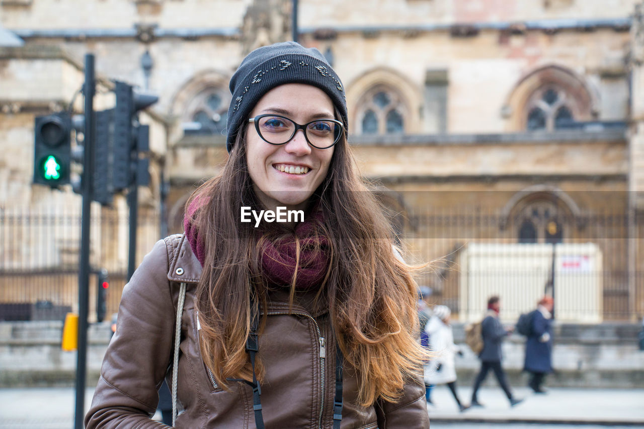 Portrait of young woman in city