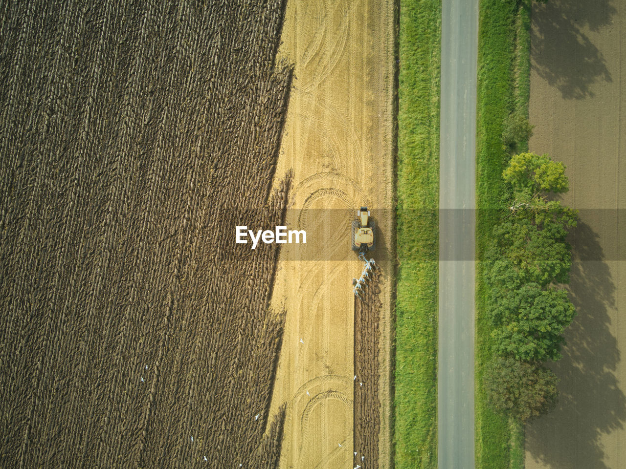 Drone aerial shots of a tractor ploughing a field at stone creek, sunk island, east yorkshire, uk.