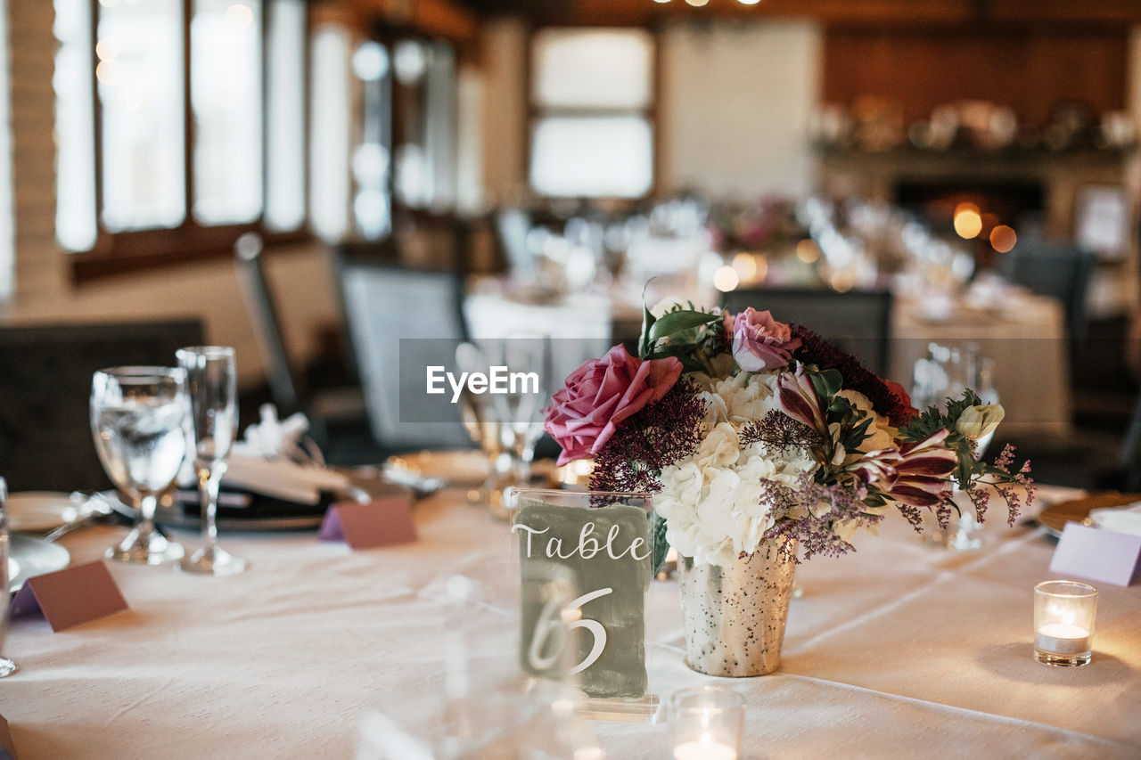 FLOWER VASE ON TABLE AT RESTAURANT