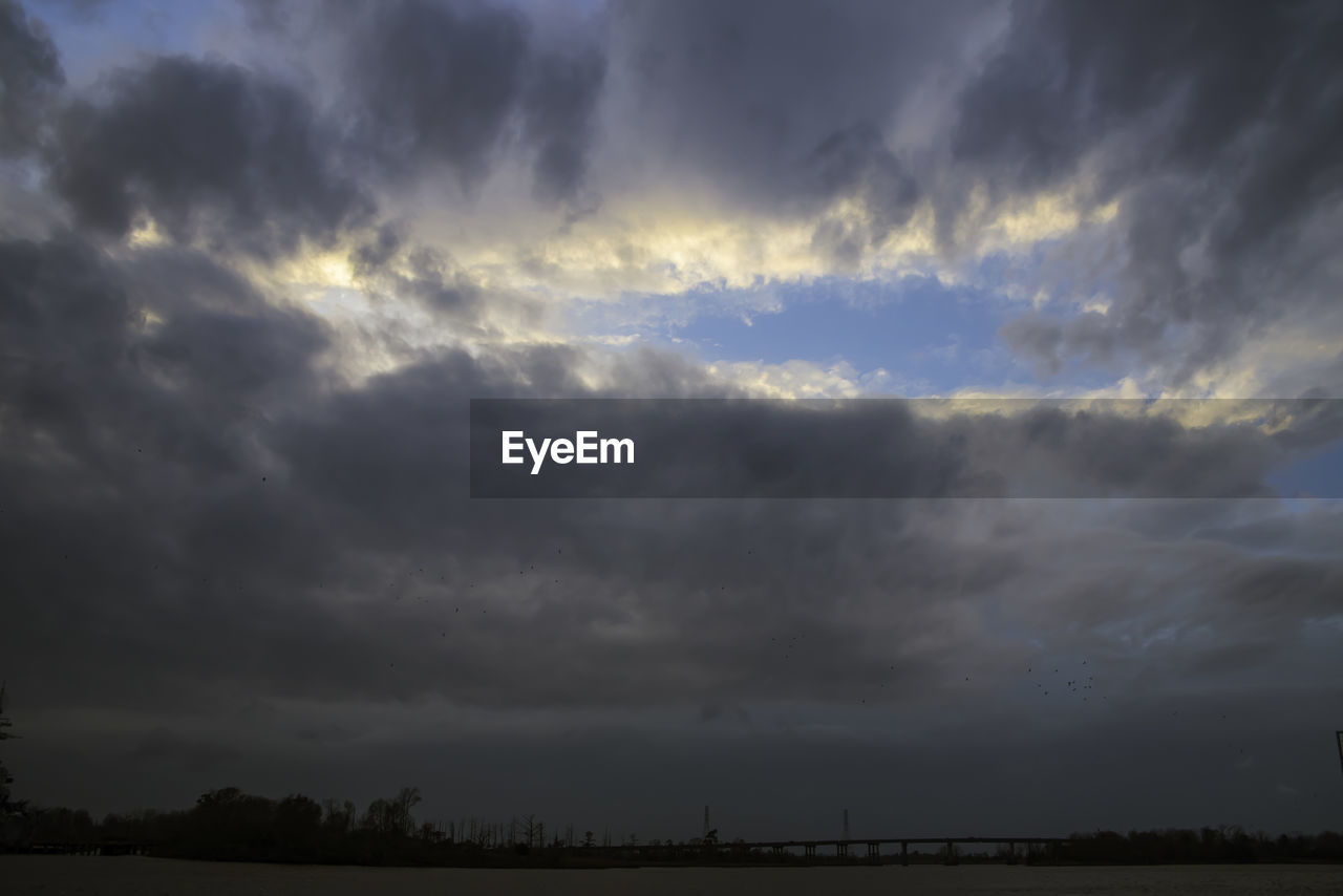 SCENIC VIEW OF STORM CLOUDS OVER LANDSCAPE