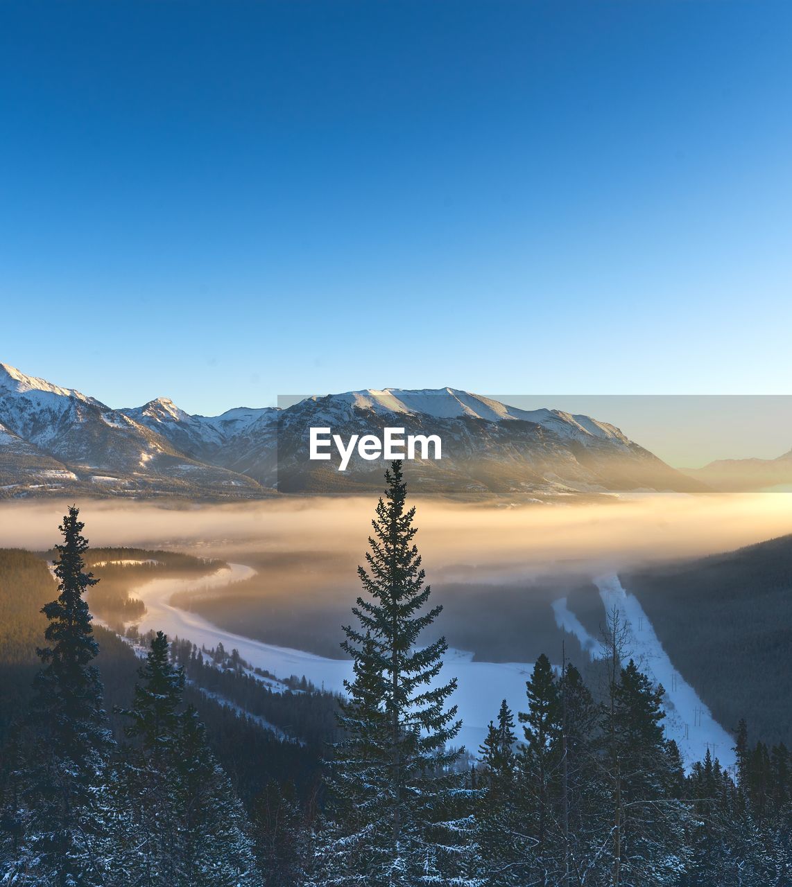 Scenic view of mountains against clear sky during winter