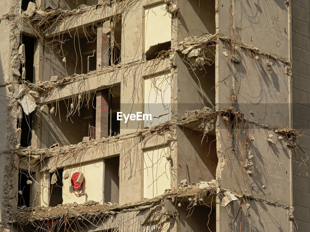 LOW ANGLE VIEW OF BUILDING SEEN THROUGH BROKEN WINDOW