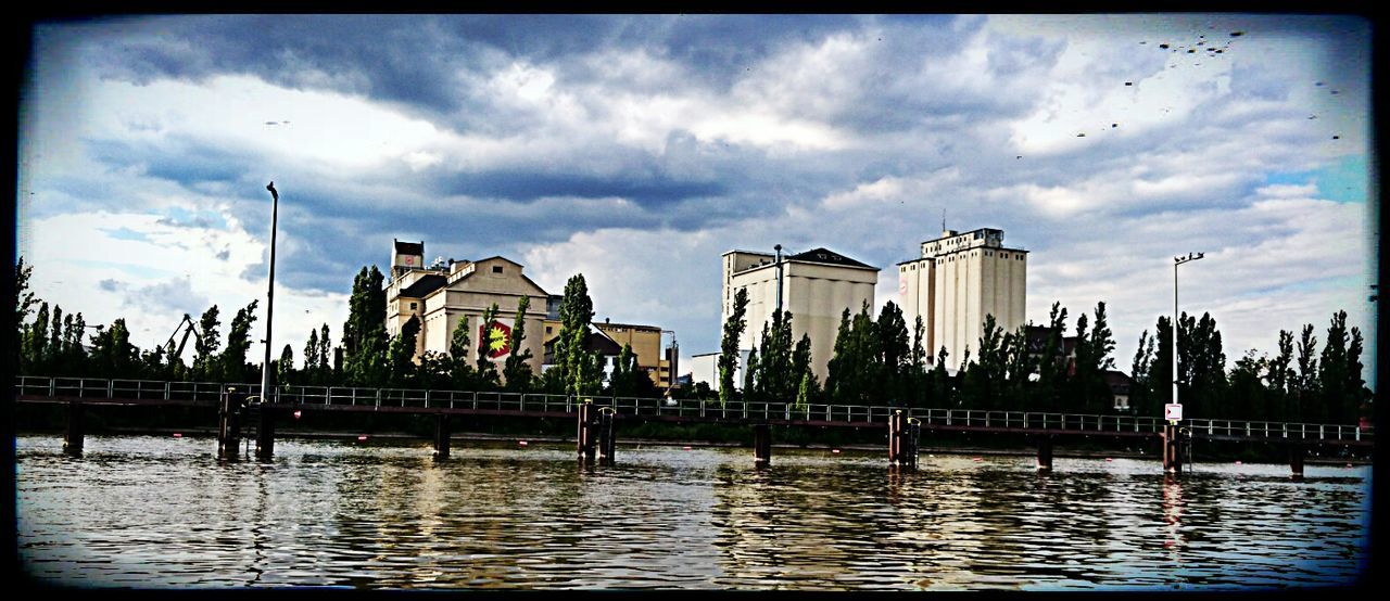 VIEW OF RIVER WITH BUILDINGS IN BACKGROUND