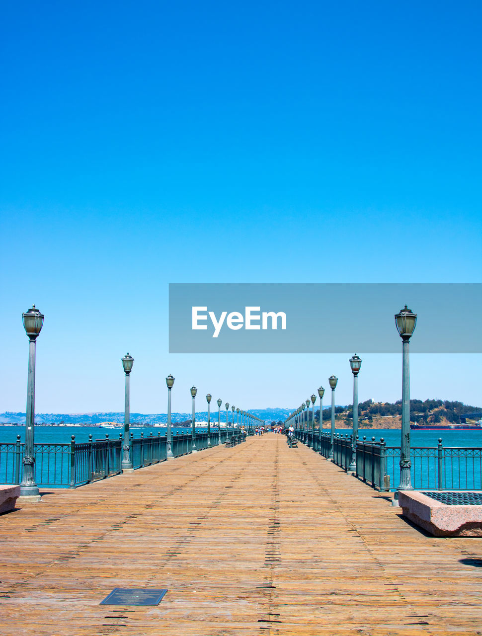 WALKWAY BY SEA AGAINST CLEAR SKY