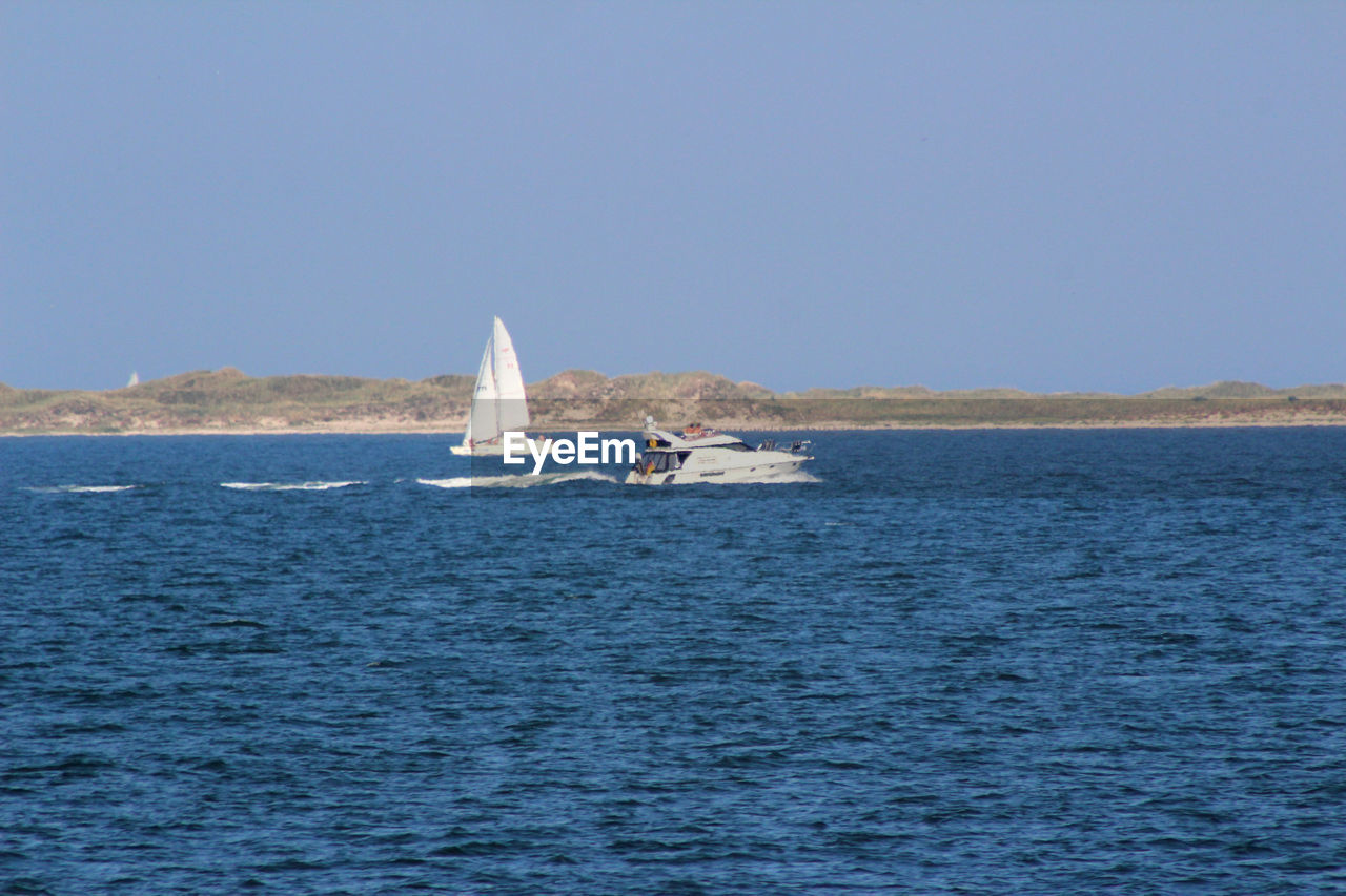 SAILBOATS SAILING ON SEA AGAINST CLEAR SKY