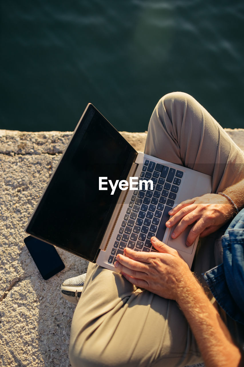 High angle view of man using laptop