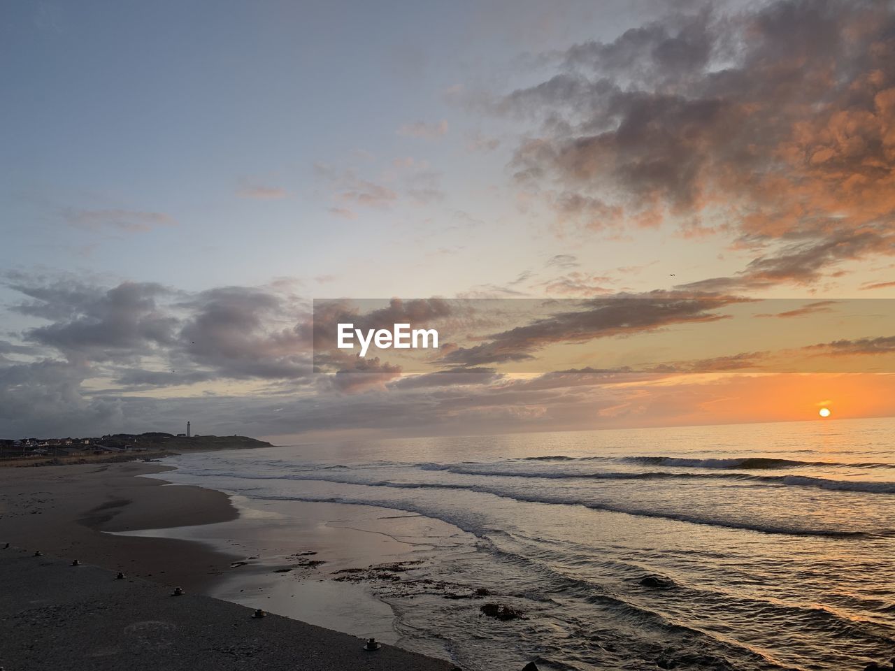 Scenic view of beach against sky during sunset