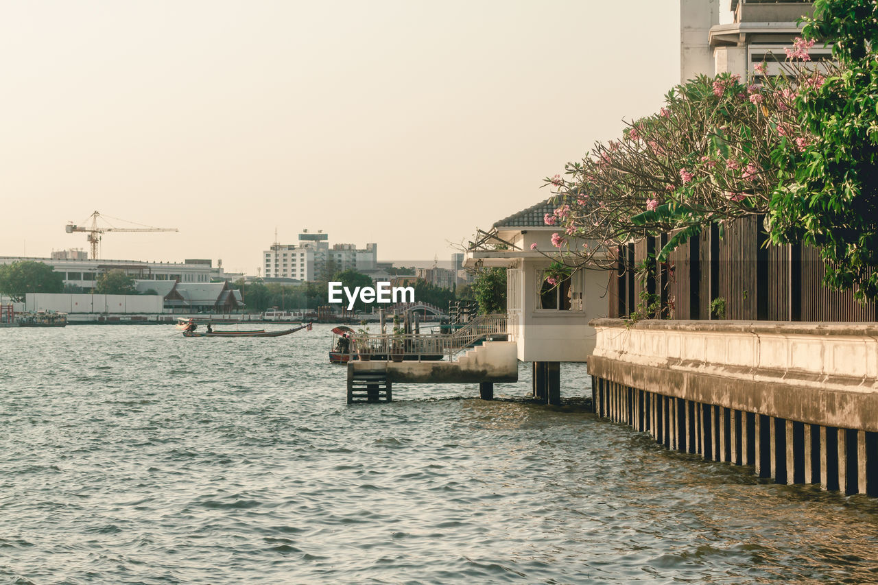 SCENIC VIEW OF RIVER BY BUILDINGS AGAINST SKY