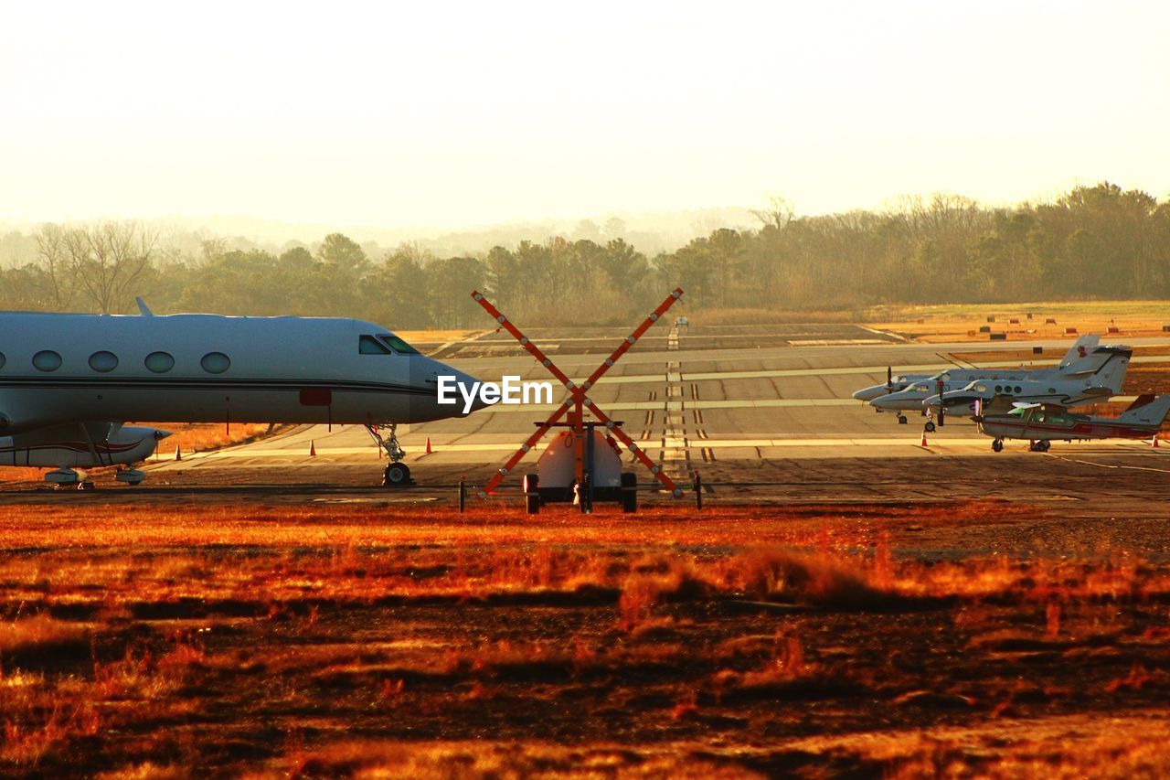 AIRPLANE ON RUNWAY AGAINST SKY