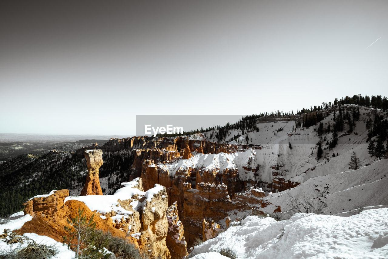 Desaturated monochrome fine art photo style of bryce canyon national park during the day in winter