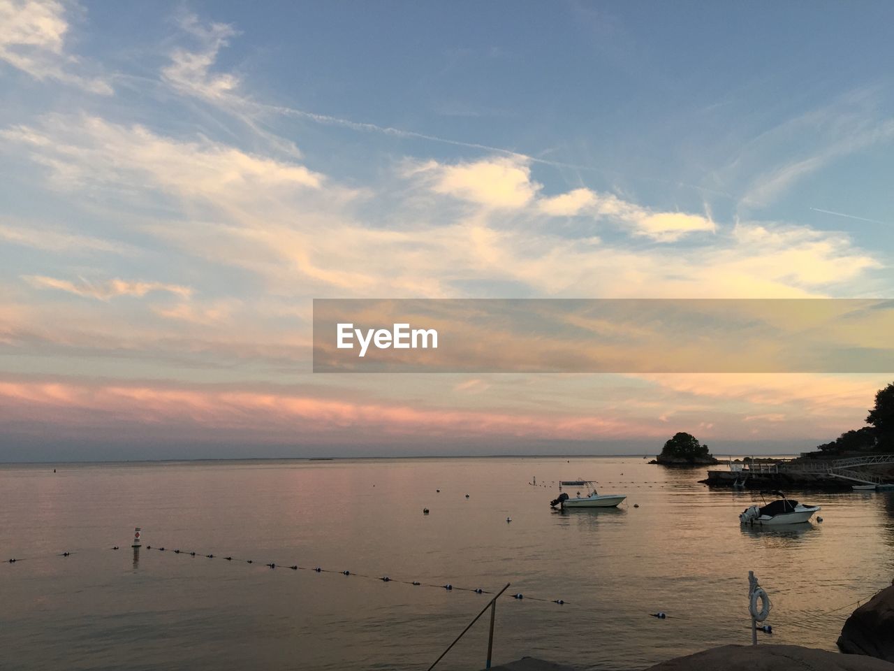 Scenic view of calm sea against cloudy sky