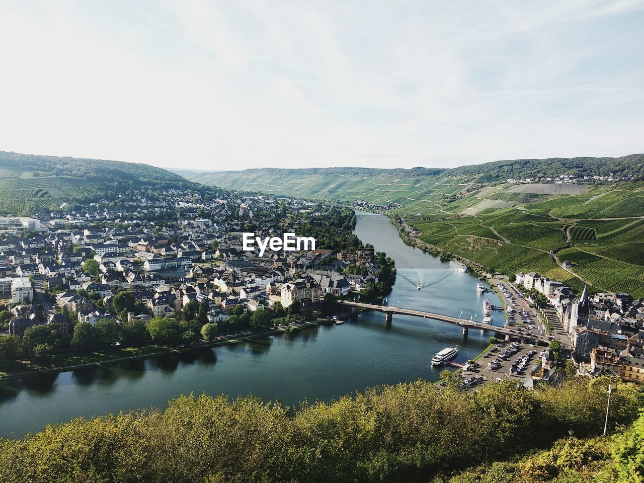 Scenic view of river by buildings against sky