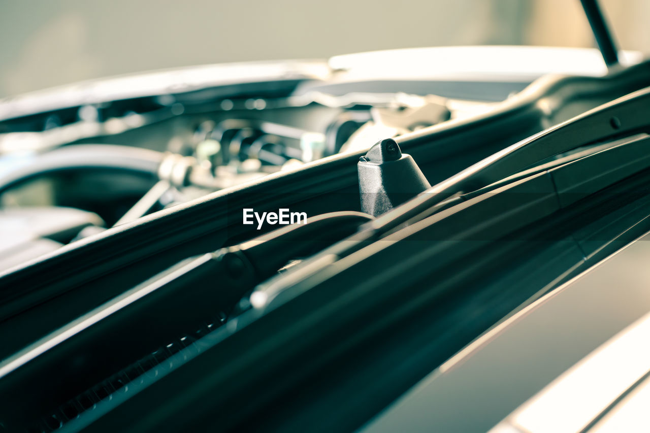 Details of car engine, windshield washer nozzle, shallow depth of field