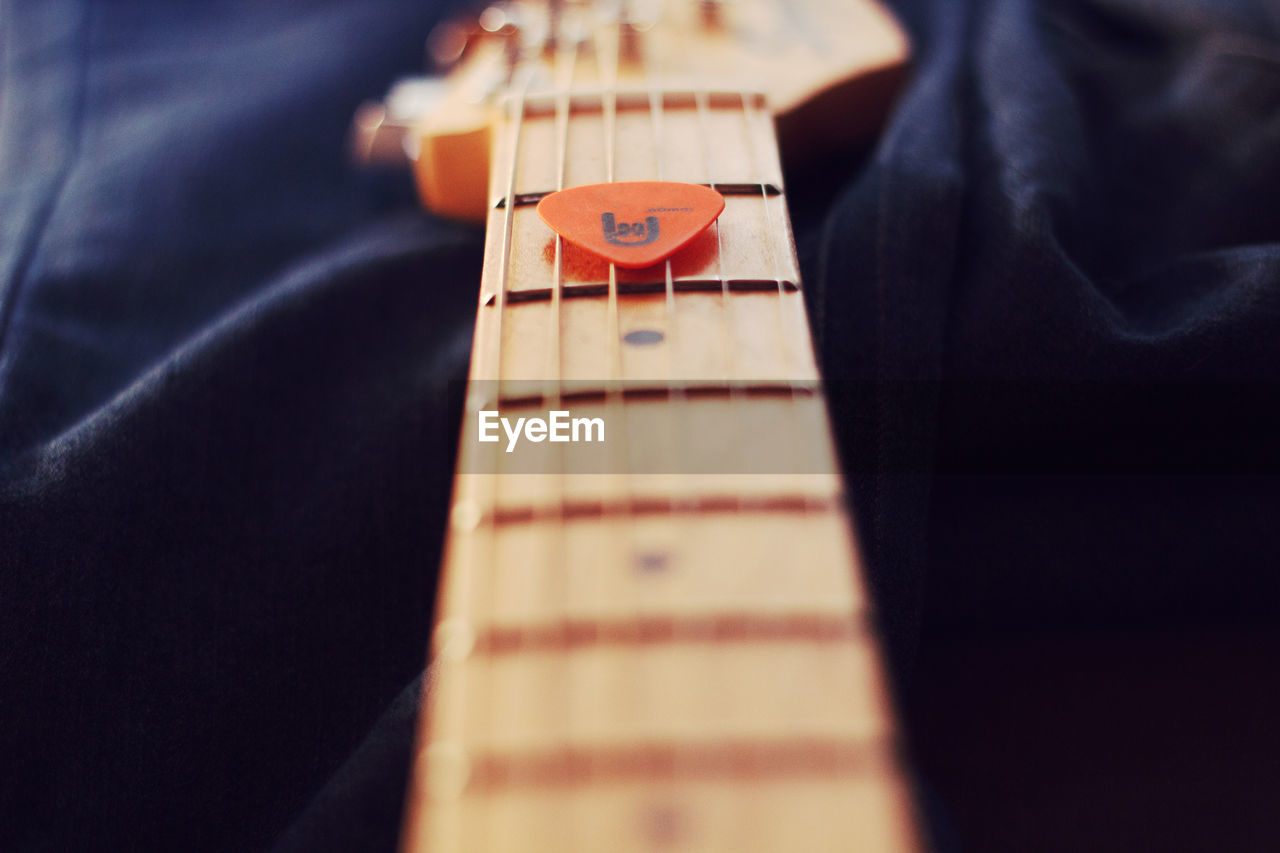 CLOSE-UP OF A GUITAR ON THE FLOOR