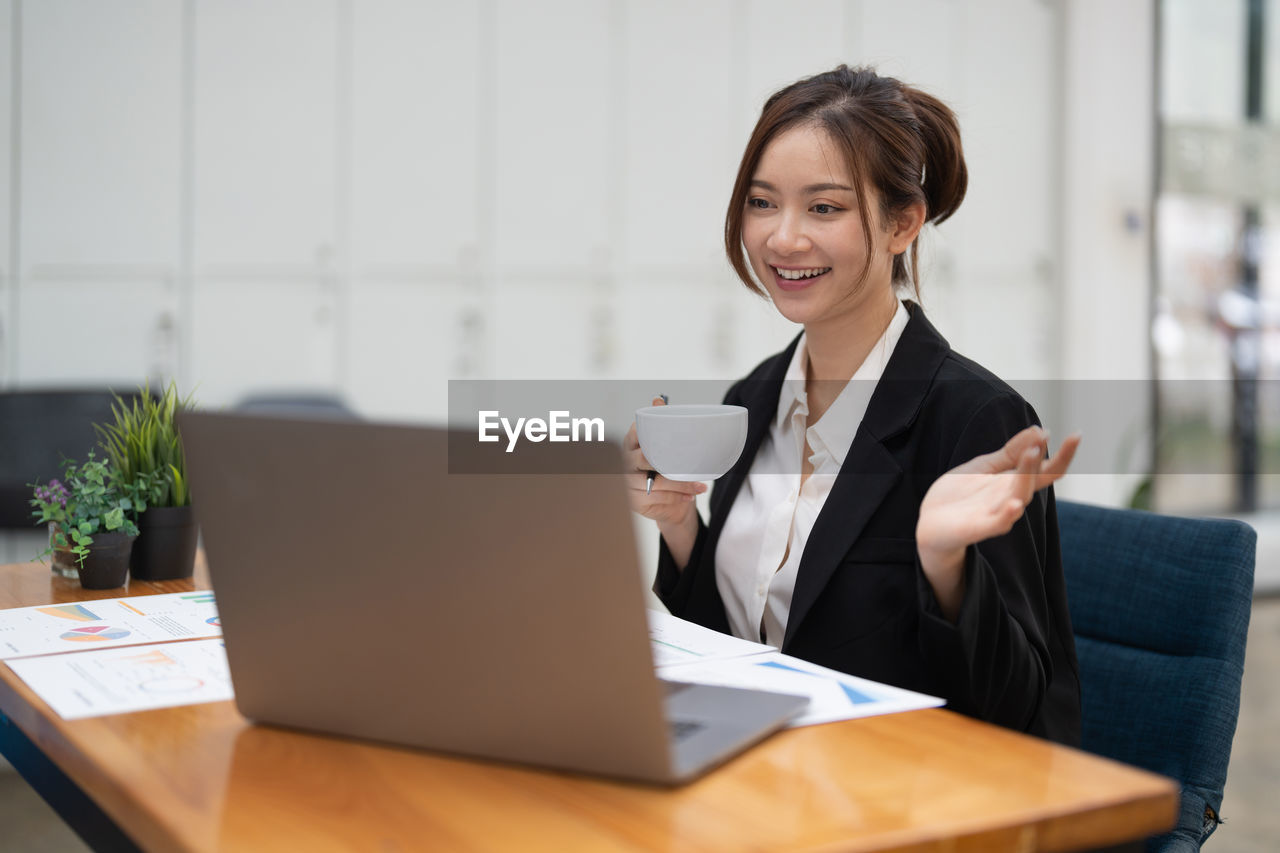 portrait of businesswoman using laptop at table