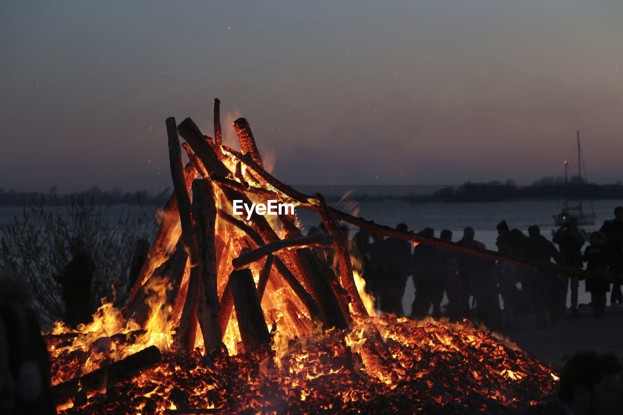 night, nature, burning, fire, bonfire, flame, sky, camping, heat, land, campfire, environment, water, travel destinations, wood, motion, outdoors, long exposure, glowing, beach, dusk, landscape, beauty in nature, evening, illuminated, winter, travel, orange color, tourism