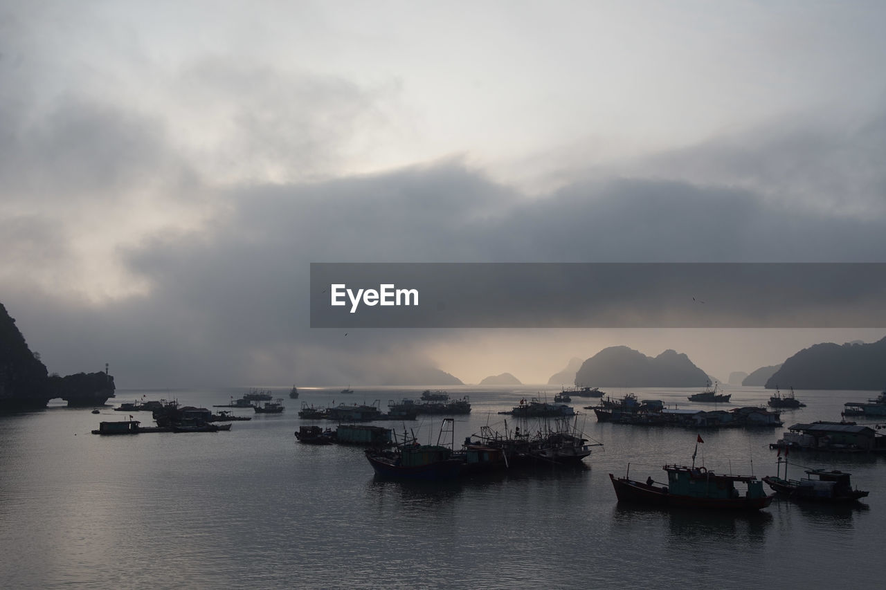 BOATS IN SEA AT DUSK