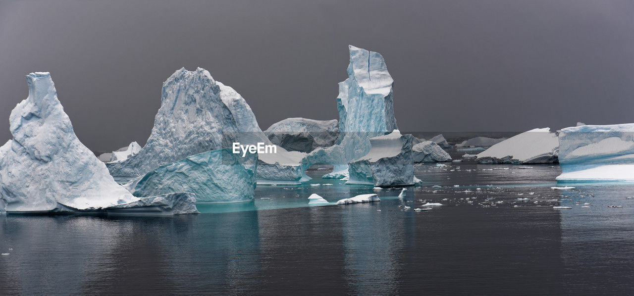 Colourful iceberg sculptures in antarctic ocean near horseshoe island