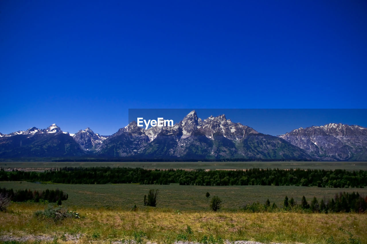 SCENIC VIEW OF SNOWCAPPED MOUNTAIN AGAINST BLUE SKY