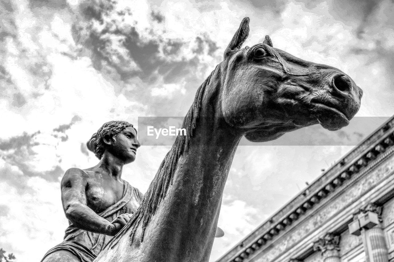 LOW ANGLE VIEW OF STATUE AGAINST SKY AND CLOUDS
