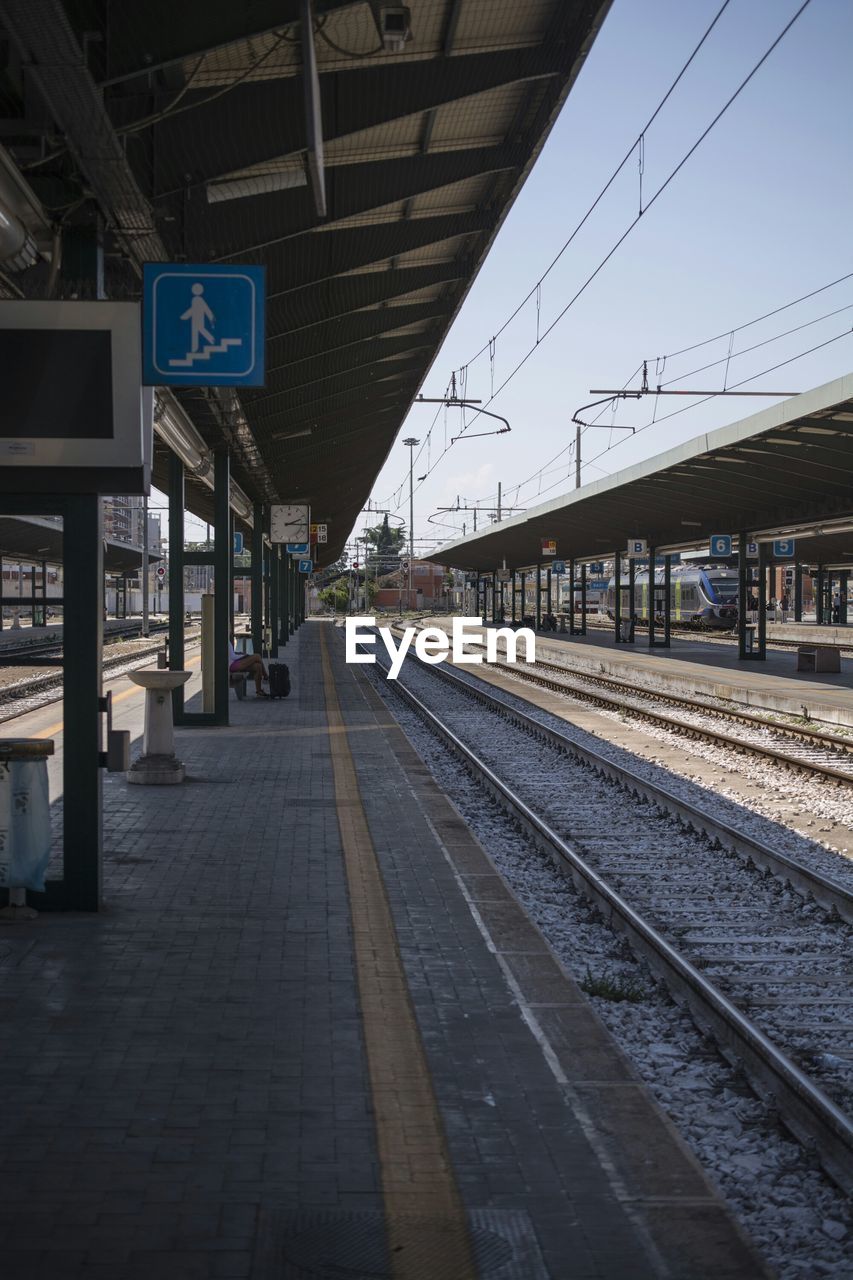 RAILROAD TRACKS ON RAILROAD STATION PLATFORM