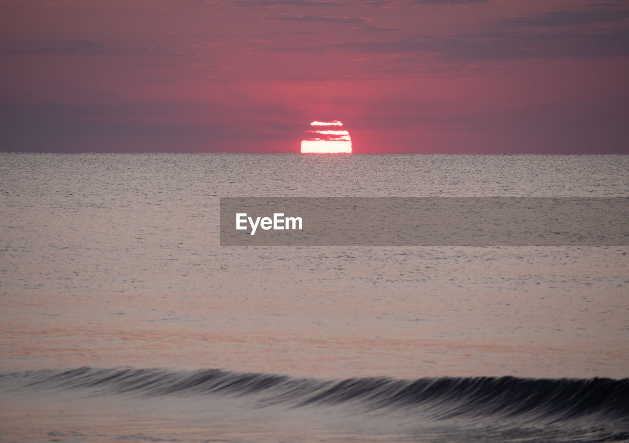 SCENIC VIEW OF BEACH DURING SUNSET