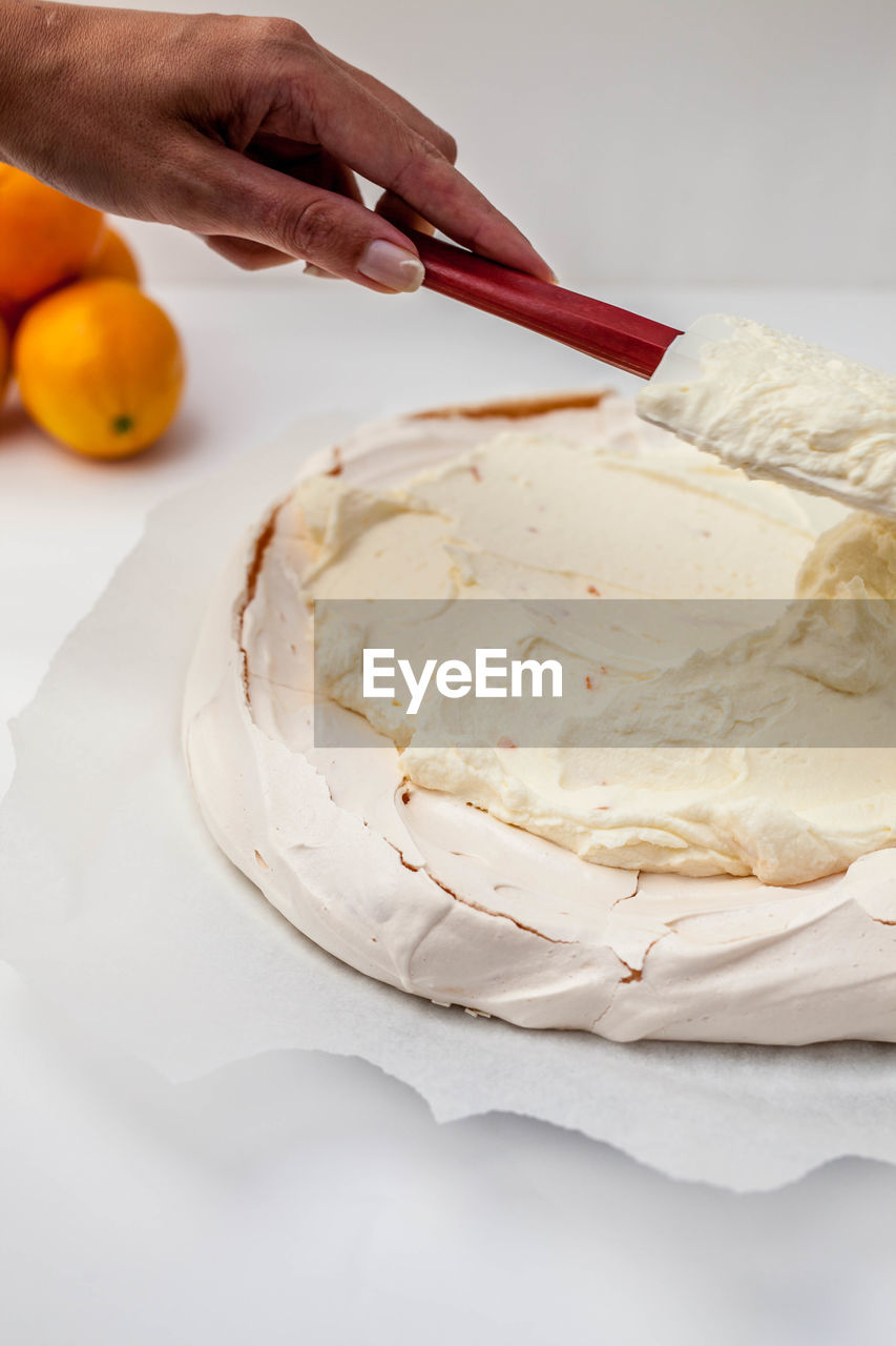 Close-up of hand holding ice cream in bowl