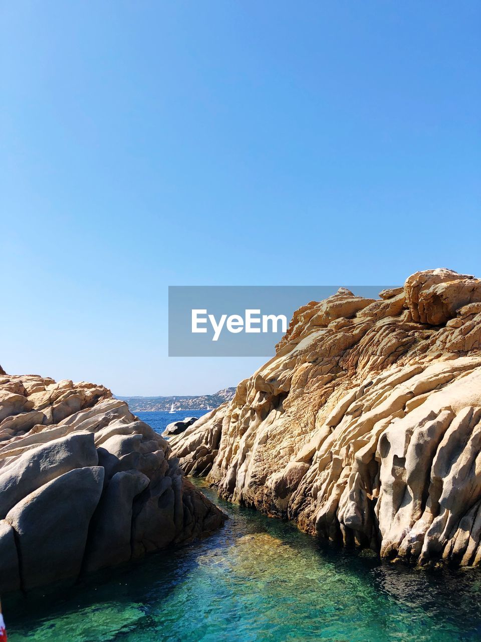 Scenic view of sea against clear blue sky