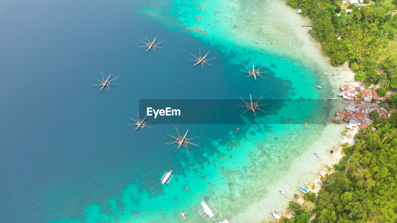 Aerial drone of village of fishermen with houses and fishing boats. samal island, mindanao.