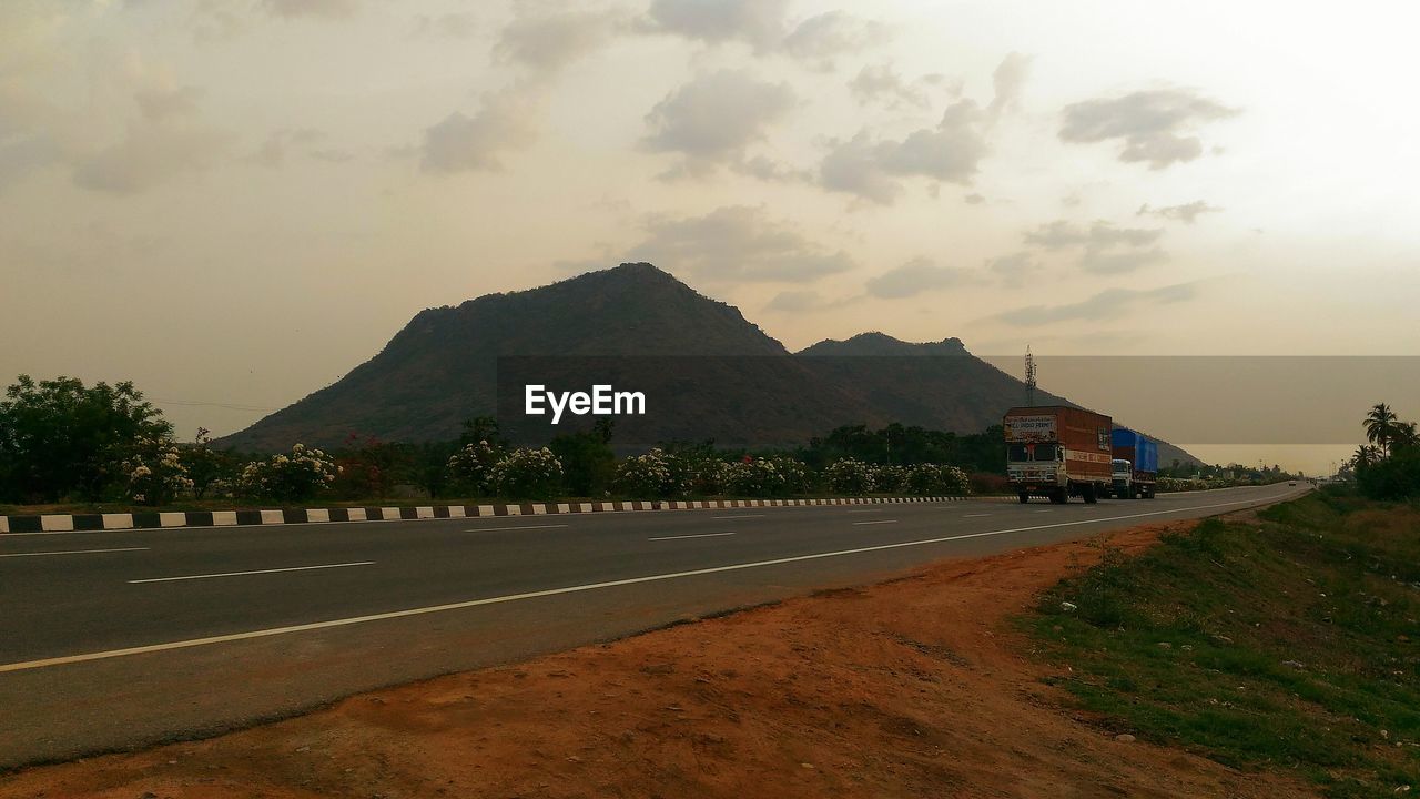 ROAD BY LANDSCAPE AGAINST SKY